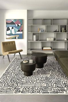 a living room filled with furniture and a colorful rug