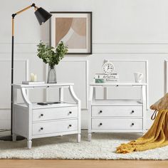 a bedroom with two white nightstands and a yellow blanket on the floor next to it