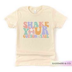 "Kids will love this \"SHAKE YOUR COTTON TAIL\" youth short sleeve tee. This lightweight side-seamed shirt maximizes comfort all day long.  Shake Your Cotton Tail Kids Shirt, Funny Easter Bunny Youth T-Shirt, Groovy Easter Bunny Retro, Christian Shirt Rabbit Tee Bunny Kids Gift 🌟100% Airlume combed and ringspun cotton (fiber content may vary for different colors) 🌟Light fabric (4.2 oz/yd² (142 g/m 🌟Retail fit RETURNS: All products are made-to-order and because of the nature of these items, all sales are final unless they arrive damaged or defective. CARE INSTRUCTIONS Machine wash: cold (max 30C or 90F); Non-chlorine: bleach as needed; Tumble dry: low heat; Iron, steam or dry: medium heat; Do not dryclean. PLEASE SEE THE SIZING CHARTS for the measurements, and please consider comparing t Spring Screen Print Stretch T-shirt, Spring Stretch T-shirt With Screen Print, Multicolor Cotton T-shirt With Funny Print, Spring Cotton T-shirt With Stretch, Stretch Cotton T-shirt For Spring, Cotton Graphic Print Short Sleeve Tops, Multicolor Stretch Cotton T-shirt, Stretch Multicolor Cotton T-shirt, Cute Stretch Short Sleeve T-shirt