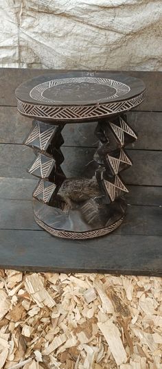 a wooden table sitting on top of a pile of wood