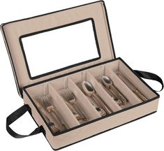 an open box with silverware in it on a white background and black ribbon around the bottom