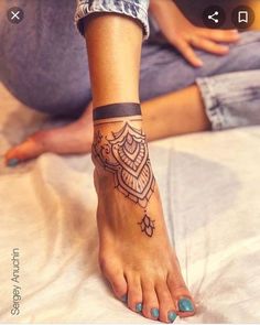 a woman's foot with a tattoo on it