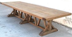 a wooden table sitting on top of a cement floor