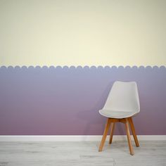 a white chair sitting in front of a purple wall