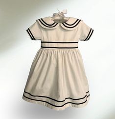 This Ralph Lauren inspired dress is white with navy blue ribbon detailing around the collar, sleeves, hem and sash.  The dress falls at knee and buttons in the back. Sizes 3 to 18 months have Kam snap's instead of buttons. The dress comes in 3 months to size 10. Please note that dress is made to order.  NOTE: There is a matching Anchors Away boys romper available in a separate listings on my Etsy page.    Measurements for Dress     3 months:    Chest 18" Finished length: 14"    6 months:    Chest 19" Finished length: 15"  12 months:   Chest 20" Finished length: 17"     18 months:   Chest 20.5 Finished length: 18"    2T:                  Chest 21" Finished length: 20"      3T:                  Chest 22" Finished length: 21"     4T                   Chest 23" Finished length: 22"       5: Eloise At The Plaza, That Dress, Sailor Dress, Nautical Style, Boys Romper, Nautical Fashion, Inspired Dress, Blue Ribbon, Anchors