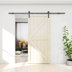 an open sliding door in a living room with a potted plant next to it