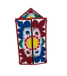 an artisticly designed wall hanging made out of wood and painted with colorful flower designs