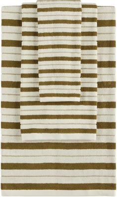 four pieces of brown and white striped bath rugs on top of eachother