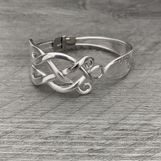 a silver ring sitting on top of a wooden table