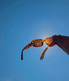 the sun is shining through some sunglasses in front of a clear blue sky with no clouds