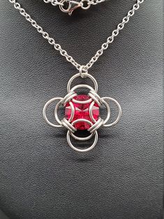 The birthstone tradition traces its roots back to ancient times, and has been found in several cultures worldwide. Garnet is recognized as the birthstone for January. While garnets can range in color from red, to yellow, to green, the most common color is a deep red, and this siam Swarovski captures its hues perfectly. Wearing the gemstone associated with your birth month is purported to bring good fortune, though it can simply make a thoughtful gift! Matching earrings available. This completed Fusion Wire Wrapped Necklace For Gift, Fusion Style Wire Wrapped Necklace For Gift, Garnet Stone Setting Jewelry Gift, Garnet Jewelry With Stone Setting For Gift, Handmade Stainless Steel Round Pendant Jewelry, Red Spiritual Metal Jewelry, Metal Necklaces With Stone Setting For Gift, Nickel Free Red Jewelry As Gift, Handmade Ruby Necklaces With Spiritual Style