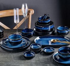 a table topped with blue dishes and glasses