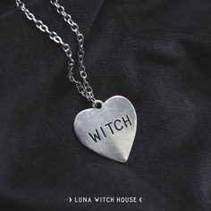 Show everyone that you're literally that witch with this heart labelled with 'WITCH' necklace! This is a beautiful gothic fashion statement! - Material Type: Zinc Alloy - Chain Length: 20 inches - Pendant Size: 2.5 cm by 2.5 cm All necklaces are inside a material pouch and then carefully placed inside an envelope lined with bubble wrap to ensure no damage in transit. *Please note that although item photography is as accurate as possible, some screens may portray the item colour slightly differen Silver Grunge Jewelry For Valentine's Day, Gothic Metal Heart Necklace, Grunge Heart-shaped Jewelry For Halloween, Gothic Heart Pendant Necklace For Halloween, Silver Heart Necklace In Grunge Style, Gothic Heart Pendant Necklace, Gothic Heart Necklaces With Heart Charm, Gothic Heart Necklace With Heart Charm, Gothic Heart Necklace With Heart Pendant