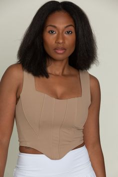 Our Brown Beige Corset Tank Top is so stunning and versatile. This corset-style tank has wide straps, a curved hem, and structured paneling on the bodice. Made for everyday, this tank is double lined for maximum support. Chic Crop Top With Built-in Bra And Wide Straps, Sleeveless Corset With Built-in Bra And Fitted Bodice, Chic Fitted Tank Top With Wide Straps, Elegant Fitted Tank Top With Wide Straps, Sleeveless Camisole With Removable Bra Pads, Fitted Bra-friendly Tank Top With Wide Straps, Fitted Tank Top With Built-in Bra And Wide Straps, Chic Tops With Boned Bodice And Tank Straps, Corset Back Top With Tank Straps