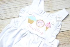 This listing is an adorable knit ruffle bubble romper with sweets trio (donut, cupcake, and ice cream) and name!  This is a perfect cake smash outfit for an ice cream, donut or summer birthday party.     Available in 3M, 6M, 9M, 12M, 18M, 2T and 3T.  These bubbles run about a size big.  Message me with questions. In Notes to seller please include:  1)  Choice of FABRIC/color scheme 2) NAME or FULL name for monogram 3) Font choice for name Current Processing time in Shop Announcement on homepage Cute Fitted Bubble Romper For First Birthday, Sweet Pink Bubble Romper For Birthday, Playful Fitted Bubble Romper For Birthday, Cute Fitted Bubble Romper For Birthday, Fitted Cotton Bubble Romper In Sweet Style, Sweet Cotton Bubble Romper For First Birthday, Fitted Bubble Romper With Ruffles For Birthday, Fitted Ruffles Bubble Romper For Birthday, Sweet White Bubble Romper For First Birthday