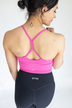 IDEAL FOR: Yoga + Barre + Pilates, Dance, Low Impact Workout, Cardio, Casual Wear. FEELS LIKE: Designed with a lightweight fabric which is incredibly soft and features 4-way stretch and high retention. WHY WE LOVE THEM: Just like our original Fan-favorite Solar Tank- but with extended tummy coverage, size options, and sporting our gold logo! We LOVE this top because it can be worn on it's own as a tank or layered underneath as a bra. This top features a flattering V-neckline with a unique gather High Stretch T-back Tops For Sports, High Stretch T-back Sports Tops, Racerback Activewear With Built-in Bra For Light Exercise, Activewear With Built-in Bra And T-back, High Stretch Activewear With Built-in Bra And T-back, High-stretch T-back Tops For Sports, Moisture-wicking T-back Tank Top For Gym, Mesh Back Sports Bra For Pilates, Medium Support Activewear With Mesh Back For Pilates