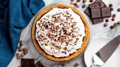 a pie with whipped cream and chocolate on top