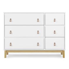 a white dresser with wooden handles and drawers