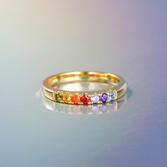 This lovely ring is embellished with 7 small colorful stones that adds a dazzling color to the fingertips. The glamorous stones glimmers in the light revealing a rainbow of colours. Thanks to the strong colors, the ring sparkles particularly beautiful on the wearer’s hand and immediately attracts all eyes.Time and again rainbows assure us that there will be beauty and clarity following times of doubt.Carat Weight: 0.71 ctStone Size: 2.0,2,2,2,2,2.0,2.0 mmStone Type: Jeulia® StoneNumber of Stones: 7 Stone Shape: RoundStone Color: Aquamarine Blue, Amethyst Purple, Orange, Garnet Red, Citrine Yellow, Peridot GreenWeight: 2.4 gMaterial: 925 SilverPlating Color: Yellow Gold Multicolor Gemstone Crystal Promise Ring, Multicolor Crystal Promise Ring, Multicolor Gemstone Promise Ring, Multicolor Stones Promise Ring, Multicolor Promise Rings With Gemstone Accents, Rainbow Promise Ring With Accent Stones, Multicolor Stackable Birthstone Ring For Promise, Multicolor Stackable Birthstone Promise Ring, Adjustable Multicolor Birthstone Promise Ring