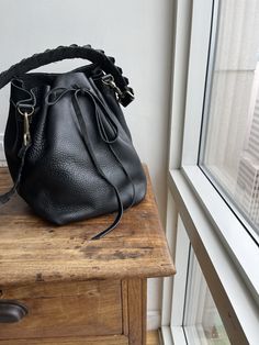 "For more handmade leather bags, purses, satchels, messengers, travel bags, holdalls, carry alls, handbags, shoulder bags, click here: http://etsy.me/1muiXbL. Mini bucket bag is a great little drawstring handbag that is made out of soft cognac leather and bridle leather strap. Its easily opened and closed with the leather drawstring and can fit an iPad mini if stretched opened. The strap is long and will fit most and comes with adjustable leather option. Made to order made from scratch leaving r Luxury Bucket-shape Shoulder Bag For On-the-go, Leather Bucket Satchel For On-the-go, Chic Bucket Bag With Leather Lining For On-the-go, Luxury Crossbody Bucket Bag For Errands, Textured Leather Bucket Bag In Pouch Shape For Everyday, Textured Leather Bucket Bag Pouch For Everyday Use, Bucket Satchel With Detachable Strap For Daily Use, Leather Crossbody Bucket Bag For On-the-go, Luxury Satchel Bucket Bag