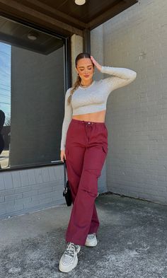 Our cargo pant obsession is still here & we got them in the PERFECT maroon shade! Pair it with a corset top for going out or a tee for a casual look! Model is 5'6" with a 32DD bust, 27" waist, 36" hips, and wearing a small. Model usually wears size 2/4. This item runs true to size! Burgundy Melina Pants, Womens Burgundy Pants, Burgundy Herim Pants, Maroon Pants Outfit Casual, Going Out Outfits Dinner, Cold Going Out Outfits, Nyc Fashion Winter