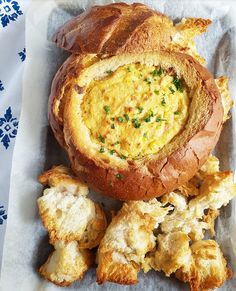 there is a bread bowl with some food in it