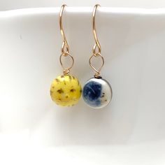 "This Tiny Sun and Moon Earring pair will cheer you up day and night:) Dimensions The earring charms are about 1/4\" (6.4mm) - 5/16\" (8mm) in diameter. Materials Porcelain Clay Underglaze Colors Mid-Fire Clear Glaze Gold overglaze Gold filled wire Care Instructions While porcelain clay is durable, it is not shatter-proof. Please wear and handle with care! The necklace may be washed with soap and water if needed. No scrubbing. PLEASE NOTE Because this is a handmade item, the item you receive wil Celestial Style Earrings With Ear Wire For Everyday, Celestial Style Everyday Earrings With Ear Wire, Everyday Celestial Style Earrings With Ear Wire, Celestial Hypoallergenic Earrings For Everyday, Hypoallergenic Celestial Earrings For Everyday, Celestial Dangle Earrings For Everyday, Celestial Style Dangle Earrings For Everyday, Everyday Celestial Dangle Earrings, Hypoallergenic Celestial Round Earrings