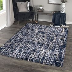 a blue and white rug in a living room