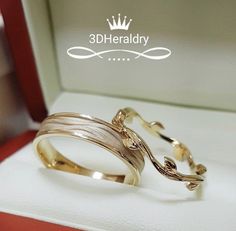 two gold wedding bands in a box