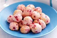 a blue plate filled with cranberry cookies on top of a table