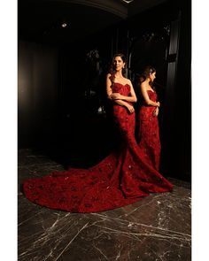 Red Corset & Fish-Cut Lehenga Set - Bora Honey's Dive into glamour with this red mermaid-style lehenga featuring a show-stopping big trail and a chic corset blouse. The corset neckline adds a touch of sophistication, while the ensemble is embellished with elongated sequins, Swarovski crystals, and sequins, ensuring a mesmerizing and opulent look that defines elegance and style. Included in Purchase: Mermaid Style Lehenga with Big Trail, Corset Blouse Product Specification Color: Red Fabric: Tull Red Bollywood Evening Gown, Red Party Wear Gown For Reception, Red Mermaid Hem Gown With Sweep Train, Red Mermaid Gown With Sweep Train, Red Floor-length Evening Dress For Reception, Red Floor-length Party Gown, Red Bollywood Evening Dresses, Fitted Red Sharara For Evening, Bollywood Style Red Evening Dress