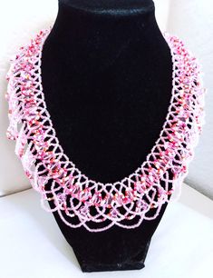 A handmade glass beaded necklace that is perfect for any occasion: parties, holidays, birthdays, anniversaries. All products are hand-crafted by my mother. Dimensions: - Actual Length: 24.1 cm - Collar Length: 20.5 cm - Width: 18.2 cm - Height: 2.0 mm Lightweight, high quality with a beaded hook as a clasp.  Acrylic Pearls: 8 mm. Will respond to concerns and suggestions promptly. Shipping costs: Free Domestic Shipping. All orders are sent by air-mail with tracking number. Time of delivery: Estimated 1-3 days for domestic shipping; international make take 7-14 days. Feel free to check out our other similar products! Link: https://noorsjewelers.etsy.com Handmade Pink Crystal Necklaces With Round Beads, Handmade Pink Crystal Bead Necklace, Handmade Beaded Necklaces With Round Beads For Celebration, Pink Czech Glass Necklaces With Colorful Beads, White Bohemian Beaded Necklaces For Celebration, White Bohemian Beaded Necklace For Celebration, Pink Beaded Necklaces With Round Beads For Crafting, Handmade Beaded Bracelets With Round Beads For Celebration, Round Bead Caps Necklace Perfect For Gifts