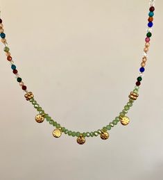 This beautiful multicolor gemstone necklace is a perfect gift for your loved ones; girlfriend, wife, mom, sister, best friend. This delicate, brightly colored necklace is the perfect fashion accessory and would complement any Mediterranean style. It is modern but inspired by antique jewelry. It is handmade with delicate brightly colored glass beads and finished with zamac gold coins made in Greece. Care instructions; Avoid contact with water or chemicals to preserve the gold plating and shine. Spiritual Festival Jewelry With Dangling Beads, Handmade Green Crystal Long Necklace, Bohemian Green Crystal Necklace With Colorful Beads, Bohemian Handmade Dangle Charm Necklaces, Green Spiritual Necklace For Festival, Bohemian Handmade Dangle Charm Necklace, Green Spiritual Necklace For Festivals, Festival Necklace With Adjustable Chain, Bohemian Green Choker As Gift