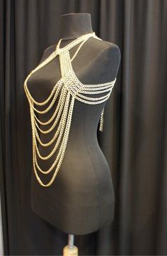 Here's a great and totally unique body chain necklace that makes the old 'little black dress' take on a whole different meaning! This gold body chain as I like to call it, adds the perfect amount of deco to your once all too simple party dress. It also looks great worn over a loose shirt, with jeans, conforming to the body in all the right places. Its great for a cocktail party or a night out at the clubs, this is definitely an attention grabbing piece. Would you like to see more body chain jewe Gold Harness, Jóias Body Chains, Body Chain Necklace, Body Jewerly, Body Necklace Chain, Body Chain Harness, Chain Harness, Body Necklace, Gold Body Chain