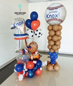 balloons and sports balls are on display in the hallway