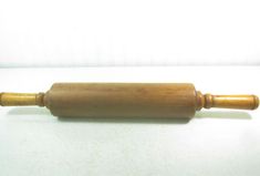 a wooden rolling pin sitting on top of a white table