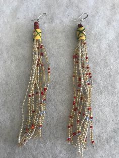 This is an elegant  and unique beaded earring made of African beads in Bohemian style!  Length is approx between 5-6"inches.  Buy any 3 beaded pairs for $25. Please message me first with you choice of 3.  Please note that colors in pictures may appear to be a little different from the actual earring. Unique Beaded Earrings For Festive Occasions, Unique Festive Beaded Earrings, Yellow Beaded Czech Glass Earrings, Yellow Beaded Earrings In Czech Glass, Yellow Beaded Earrings With Czech Glass, Bohemian Czech Glass Earrings With Dangling Beads, Unique Festive Earrings With Dangling Beads, Bohemian Dangle Earrings With Large Beads, Unique Adjustable Beaded Earrings With Large Beads