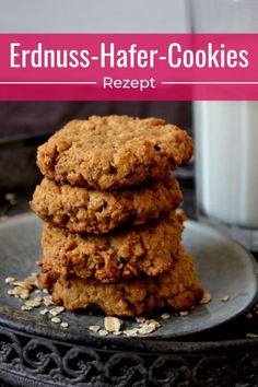 three cookies stacked on top of each other next to a glass of milk