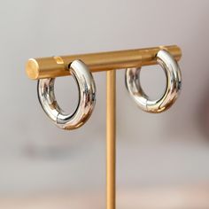 Get on trend this summer with these chunky and thick huggie hoops in either gold or silver tone. This is a beautiful and fun pair of stainless steel chubby huggies in either 12mm or 16mm. You can choose between rhodium silver plated or gold plated and enjoy these in fashion hoops all beach day long! All earrings come beautifully and simply packaged in a box and bow ready for gifting. CARE INSTRUCTIONS• It is not recommended to sleep, shower or exercise in plated jewelry. Trendy Silver Hypoallergenic Huggie Earrings, Trendy Hypoallergenic Silver Huggie Earrings, Trendy Silver Round Huggie Earrings, Trendy Chunky Hoop Earrings Gift, Trendy Small Hoop Stainless Steel Earrings, Trendy Chunky Hoop Earrings For Gifts, Polished Metal Huggie Earrings, Trendy Stainless Steel Huggie Hoop Earrings, Huggies Hoop Earrings