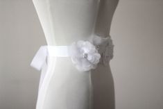 "An accessory to complement your beautiful wedding dress Flowers made of organza. The belt made ribbon and length is approximately 80\"dimensions, width is 1,18\" Pearl or rhinestone can be used according to your preference in the middle of the flowers . Belt in the first photo is the color of ivory. Other photos are white. Please feel free to contact for questions and requests. PACKAGE ARE SENT BY FAST SHIPPING COMPANY WITHIN 3 TO 4 BUSINESS DAYS, TO UNITED STATES, TO CANADA, TO UNITED KINGDOM, Elegant Bridal Belt With Flower Decoration For Wedding, Elegant Ribbon Bridal Belt For Wedding, White Bridal Belt With Ribbon For Wedding, Fitted Bridal Belt With Ribbon For Wedding, Elegant Bridal Belt With Flower Decoration, Wedding Dress Flowers, Wedding Dress Belt, Wedding Sash Belt, Wedding Dresses With Flowers