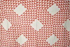 an orange and white quilt with arrows on it