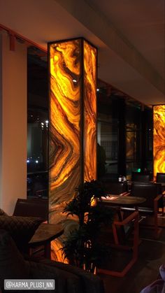 the interior of a restaurant with large glass panels on the walls and tables in front of them