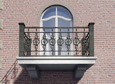 a balcony with wrought iron balconies and an arched window on the side of a brick building