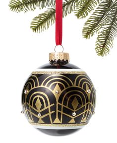 a black and gold christmas ornament hanging from a tree