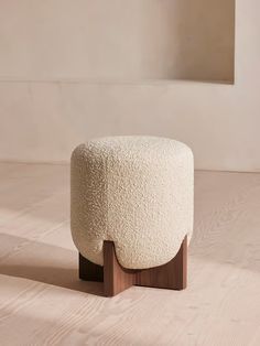 a white stool sitting on top of a hard wood floor