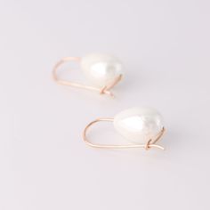 These Ceramic Pearl Earrings make a statement with their elegant, teardrop dangle and luxurious gold filled finish. Perfect for adding a touch of sophistication and class to an everyday look, they'll become your new go-to accessory. Dare to be bold and stylish!• Sold in pairs• Available in: High Quality Solid 925 Sterling Silver, Gold filled 12K and Rose gold filled 12K• Pearl drop size: 2cm x 1.5cm• Wire Thickness - 1mm (18gauge)• Length of the earrings: 3cm Minimalist Teardrop Earrings For Party, Teardrop Linear Earrings For Party, White Teardrop 14k Gold Filled Earrings, White 14k Gold-filled Teardrop Earrings, White 14k Gold Filled Teardrop Earrings, Modern Teardrop 14k Gold Filled Jewelry, Modern 14k Gold Filled Teardrop Jewelry, Party Teardrop Linear Earrings, Minimalist Teardrop Earrings With Matching Jewelry