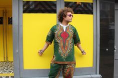 This deep green Dashiki suit is an instant fav of ours. A colourful and comfy  African print mens shirt, made from 100% wax print cotton is teamed with our ridiculously comfy trousers. This colourful print shirt has a funky Dashiki design and looks just at amazing at a formal event as it does on a festival field! We care about how our products are made, by whom, and why. We believe we are more than just a clothing brand. We Are A Brand With A Purpose.  Feel Good in our clothing, knowing that we Green Cotton Bohemian Set, Green Bohemian Cotton Set, Printed Green Sets For Festivals, Green Printed Sets For Festivals, Bohemian Green Short Sleeve Set, Green Bohemian Short Sleeve Set, Ankara Suit, Comfy Trousers, Costume Africain