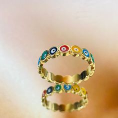 A beautiful multicolor Turkish Eye ring that serves to protect you against all evil. This dainty piece can be stacked with other rings of your liking to enhance your look and leave you making a statement! -Band Width: 4mm -Perfect for all time. -High-quality Ring! FAST & FREE SHIPPING!! Our handmade products are rated very high by our customers. We work hard with our Quality Control department to ensure the quality you deserve. -New! -Very good quality. Looks even better in person. -This is a pr Adjustable Multicolor Rings For Gifts, Multicolor Hypoallergenic Rings For Gifts, Multicolor Open Ring Stackable Rings As Gift, Multicolor Open Stackable Rings For Promise, Handmade Multicolor Metal Rings, Multicolor Metal Rings For Gifts, Adjustable Multicolor Stackable Rings, Multicolor Open Enamel Ring For Gift, Adjustable Multicolor Enamel Ring For Gift