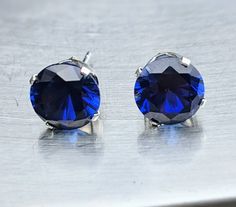 "Fast Free Shipping. Certified and tested on the most accurate gemstone testing machines. Stones came from ethical and reliable sources. You can either choose from sterling silver crown settings as in the photo or 14k solid gold basket settings. Sterling silver ships 1-3 business days. solid gold takes 2-5 Business days You will love these dark blue sapphire earrings. These high-quality Sapphire earrings will bring you focus and joy. Set in friction 4 prong setting to allow light behind the gem Sapphire Birthstone Earrings For Formal Occasions, Formal Sapphire Earrings With Birthstone, Formal Sapphire Birthstone Earrings, Diamond Cut Sapphire Earrings For Gift, Gift Sapphire Earrings With Diamond Cut, Classic Blue Diamond-cut Earrings, Classic Blue Diamond Cut Earrings, Blue Diamond Cut Round Earrings, Round Sapphire Earrings For Formal Occasions