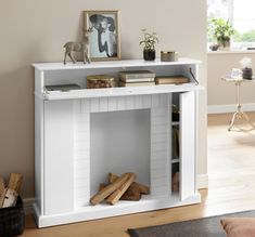 a white book shelf with books and pictures on it